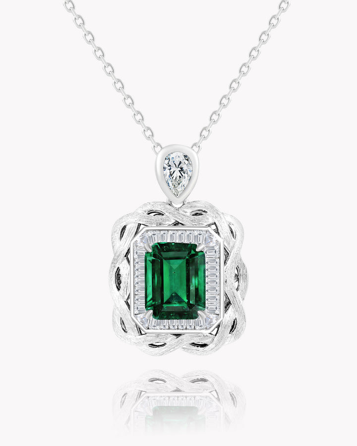 Emerald Nestled Amidst Finely Engraved Metal Lines Pendant