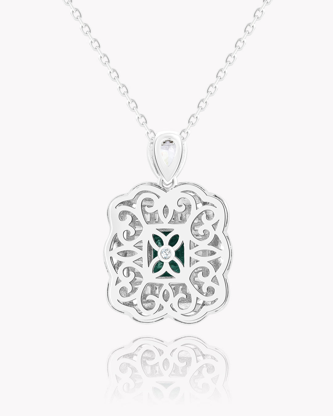 Emerald Nestled Amidst Finely Engraved Metal Lines Pendant