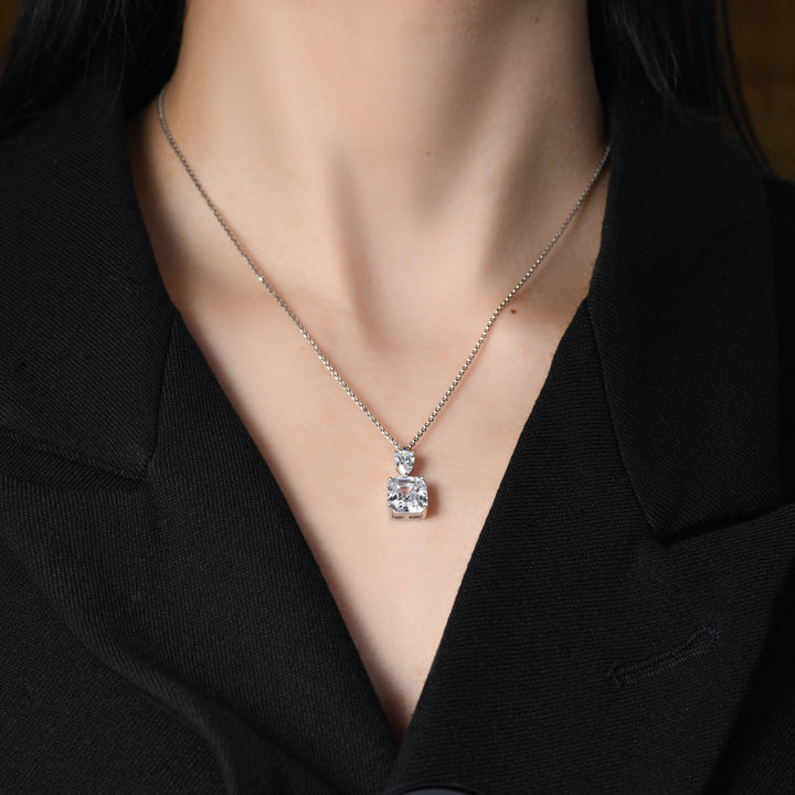 This pendant features two exquisite components - A prominent Asscher-cut white simulated diamond takes center stage, crowned by a smaller pear-shaped white diamond, creating a harmonious and elegant design.