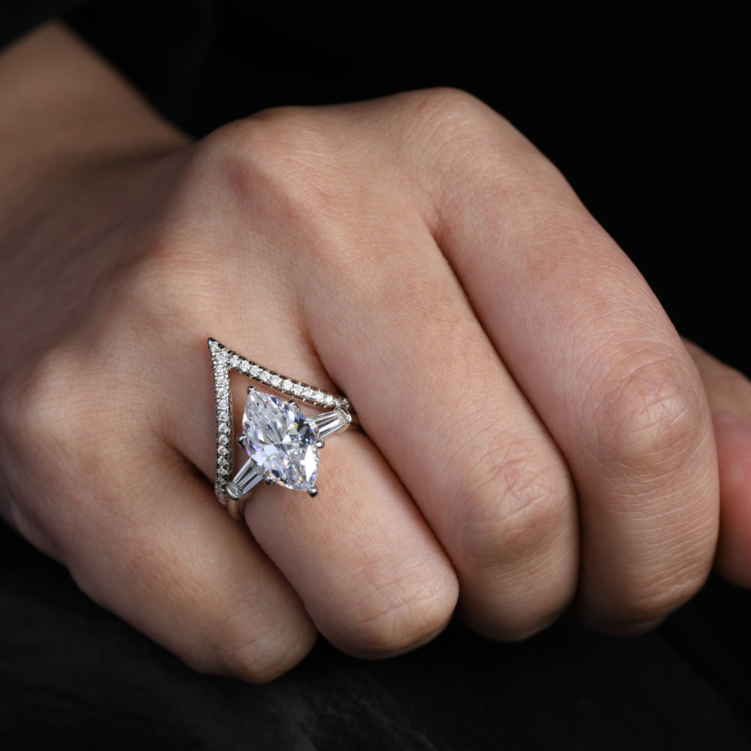 Adorn your finger with sophistication through our unique ring ensemble. The first piece showcases a prominent marquise-cut white simulated diamond, while the second, a V-shape ring, is lavishly covered with glistening white melee diamonds.